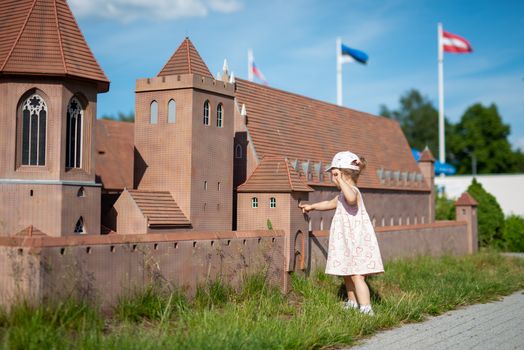 Little girl spending fantastic time on playground. Happy childhood.