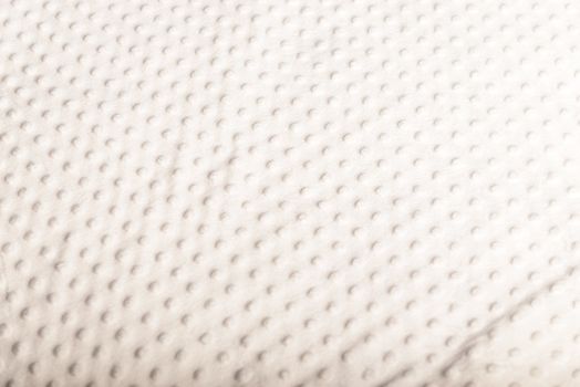 white bed cover with small green polka dot style.
