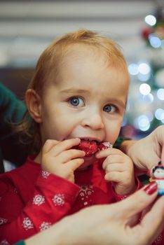 Little girl at christmas time. Christmas tree in background