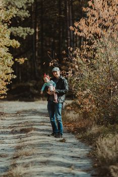 Happy loving family. Father and his daughter child girl playing and hugging outdoors. Cute little girl hugs daddy. Concept of Father's day.
