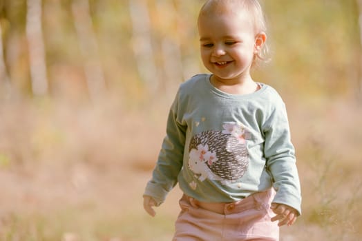 Adorable girl having fun on beautiful autumn day.