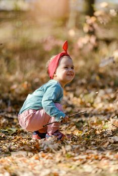 Adorable girl having fun on beautiful autumn day.