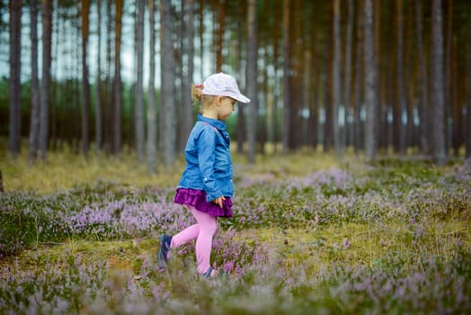 Adorable girl having fun on beautiful autumn day.
