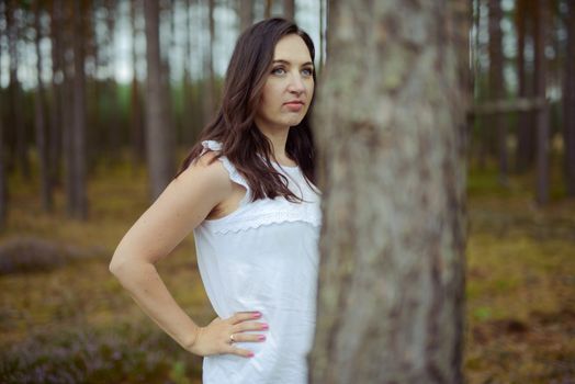 a photo of woman in the forest where the purple heather blooms. copy space