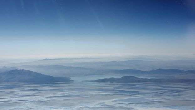 Mountains and sea in the fog. Dramatic background of blue hue. 3D illustration