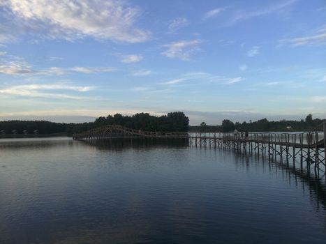 The wooden bridge with cloud sky, Nong Yai, Chumphon, Thailand.