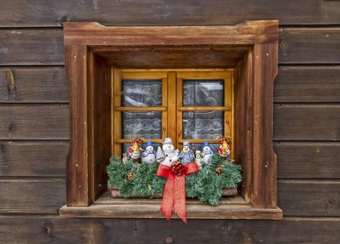 Cute Christmas decoration dolls at the window made of wood