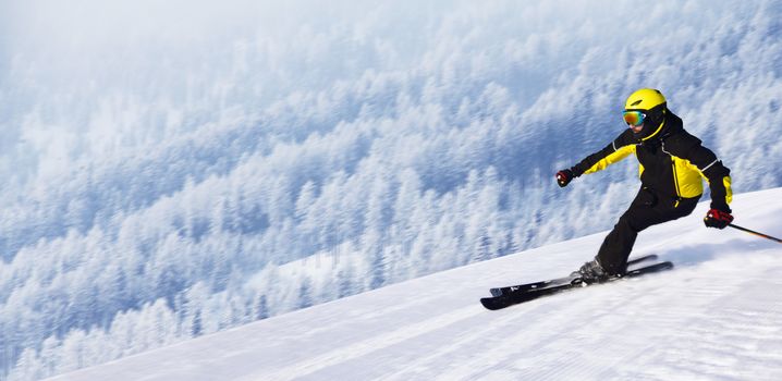 Professional alpine skier skiing downhill in high mountains of Alps