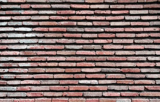 pattern background of old antique rough vintage brick stone wall close up