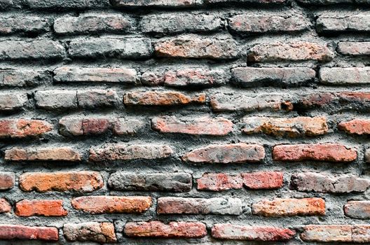 pattern background of old antique rough vintage brick stone wall close up