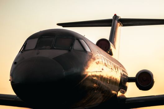 large airliner against the sunset evening sky close up