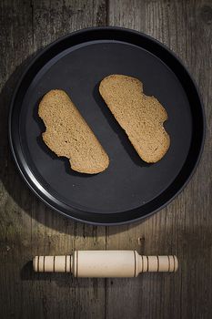 Two slices of bread on a black tray