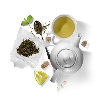 Green tea and accessories top view on white background.