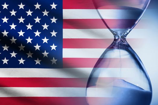 Stars and Stripes American flag with an hourglass superimposed showing sand running through measuring passing time