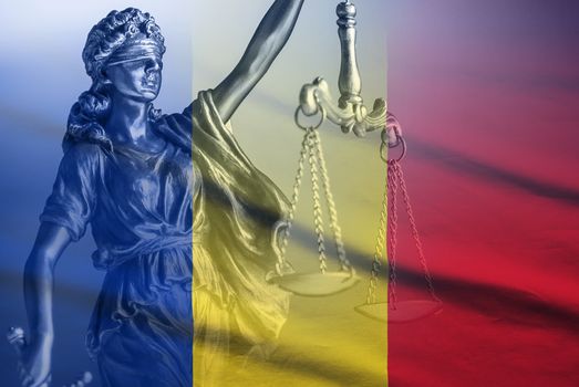 Romanian national flag with figure of Justice holding the scales and sword of law enforcement in a close up view