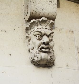 Sculpted stone mask, one of 381 mascarons on Pont Neuf - New Bridge - over the Seine in Paris