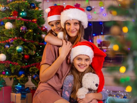 Girls hug their mother in the New Year's interior