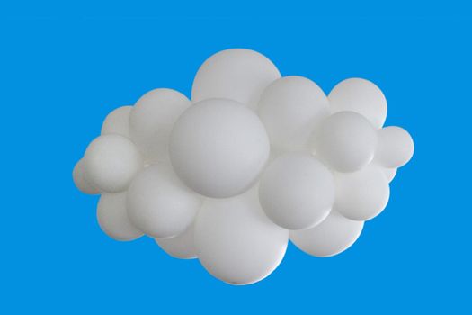 White balloons in the shape of clouds associated on a blue background