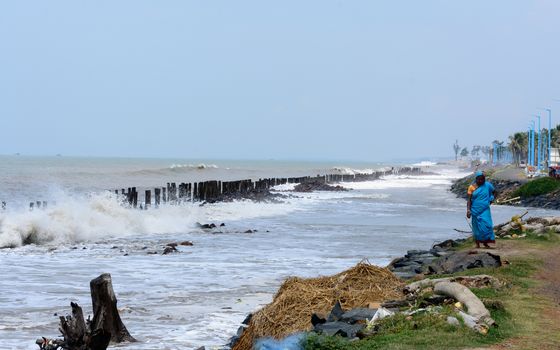 Big waves crushing on shore of a tropical beach island during storm. Stormy sea weather. Power in nature background. Taken before severe cyclone causing flood surge in coastal areas. West Bengal India