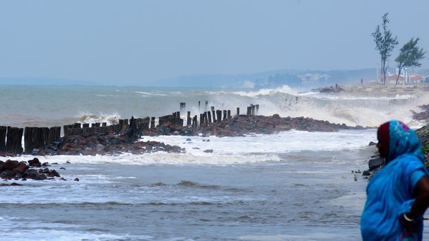 Big waves crushing on shore of a tropical beach island during storm. Stormy sea weather. Power in nature background. Taken before severe cyclone causing flood surge in coastal areas. West Bengal India