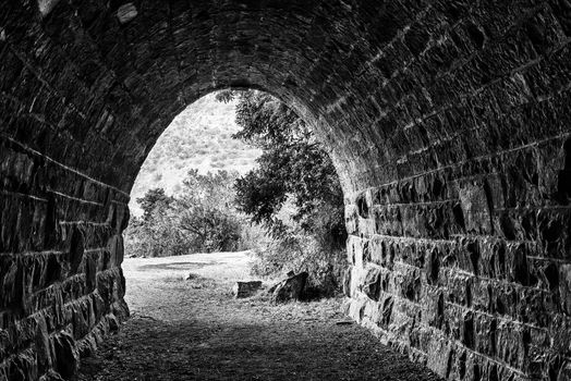 The eastern exit of the historic railroad tunnel at Waterval Boven in Mpumalanga. Monochrome