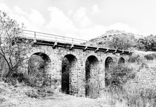 The historic Five Arch Railway Bridge over the Elands River near Waterval Boven in Mpumalanga. Monochrome