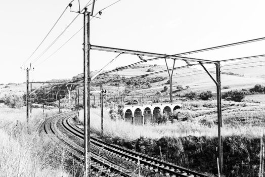 The electrified railroad between South Africa and Mozambique at Waterval Boven in Mpumalanga. Monochrome