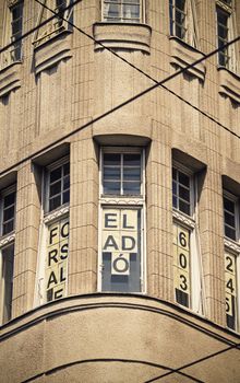 Close up shot of a building, windows framed by the electric tram cables. Close up shot of a random building in Budapest, Hungary.