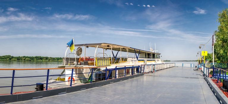 Pleasure boat at the pier in the city of Vilkovo, Ukraine on a sunny summer day