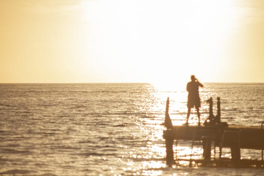 Fisherman on the pier at sunset in Bayahibe in the Dominican Republic
