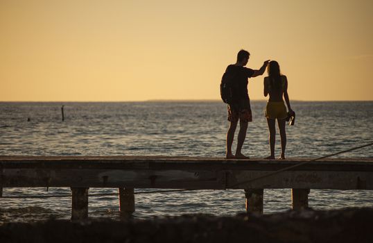 Silhouette Loving couple by the sea at sunset in Bayahibe, Dominican Republic
