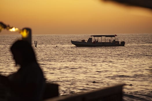 Ferry in Bayahibe at sunset time in orange hour