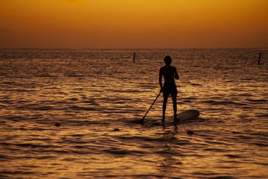 Rowing at the sea at sunset in Bayahibe, Dominican Republic