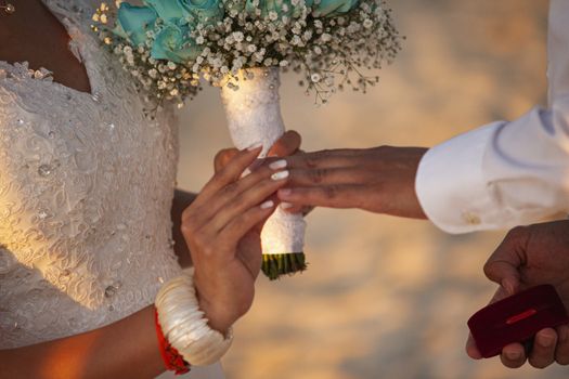 Exchange of wedding rings in caraibic wedding ceremony