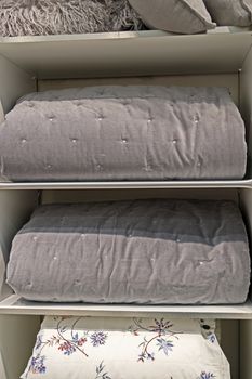 Folded thick blankets designed for the cold season. Grey, natural material.