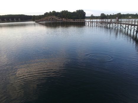 The wooden bridge with cloud sky, Nong Yai, Chumphon, Thailand.