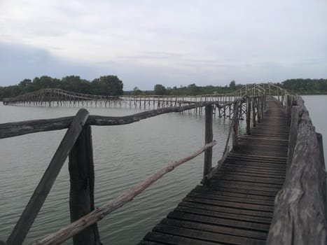 The wooden bridge with cloud sky, Nong Yai, Chumphon, Thailand.