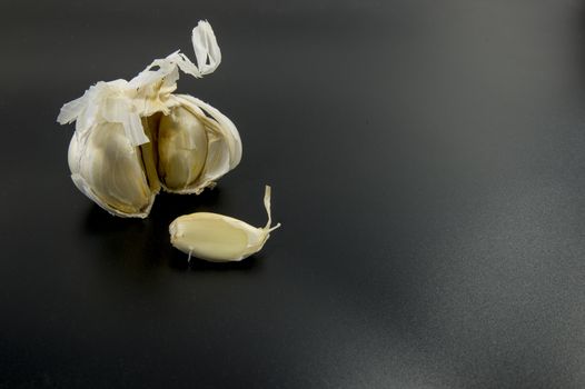 fresh garlic on black background as ingredient for food