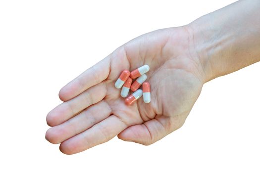 Isolated Healthcare Image Of Pills Or Tablets Or Capsules In A Person's Hand