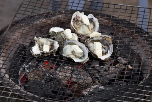 Shellfish frying on a street oven, Vietnam