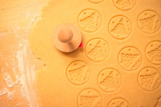 Gingerbread dough for Christmas cookies and cookie cutters.