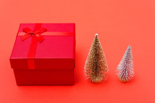 New Year, Christmas Xmas holiday composition, Top view red gift box and green fir tree branch on red background