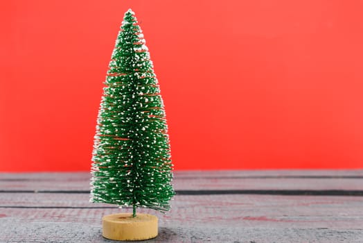 Christmas composition decorations, minimal green fir tree branches with snow on red background. Merry Christmas concept. Copy space for text