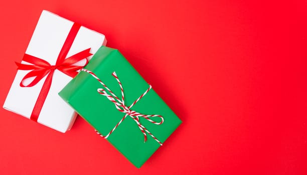 Happy New Year and Christmas 2020 day, top view Xmas white and green gift boxes on red background with copy space for your text