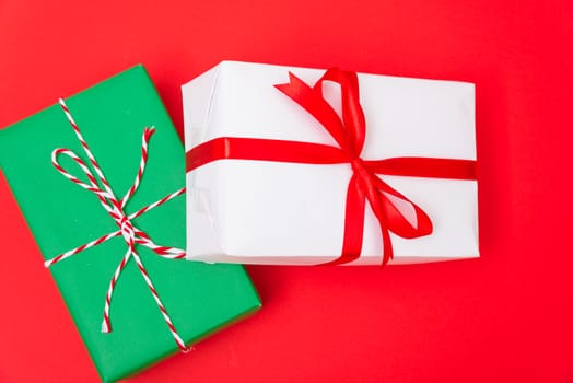 Happy New Year and Christmas 2020 day, top view Xmas white and green gift boxes on red background with copy space for your text
