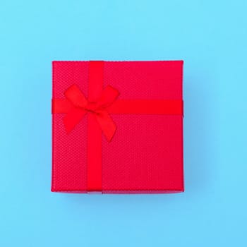Happy New Year and Christmas 2020 or valentine day, top view craft paper wrapped present red gift box craft on blue background with copy space for your text