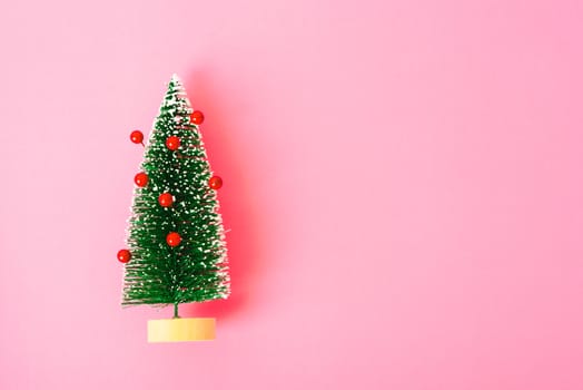 Happy New Year and Christmas day, top view flat lay composition decoration tree fir branch on pink background with copy space for your text