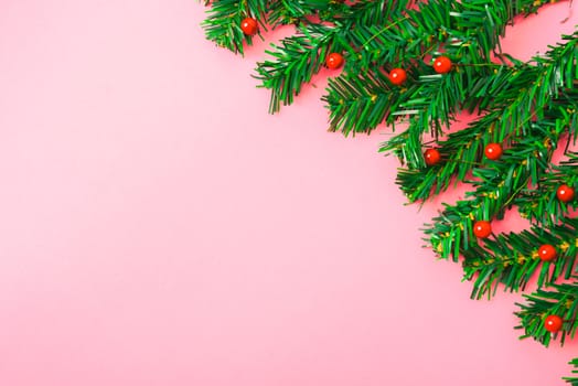 Happy New Year and Christmas day, top view flat lay composition decoration tree fir branch on pink background with copy space for your text