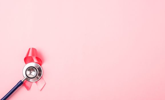 Breast Cancer Awareness Month Health concept, top view flat lay pink ribbon and stethoscope on pink background with copy space for your text