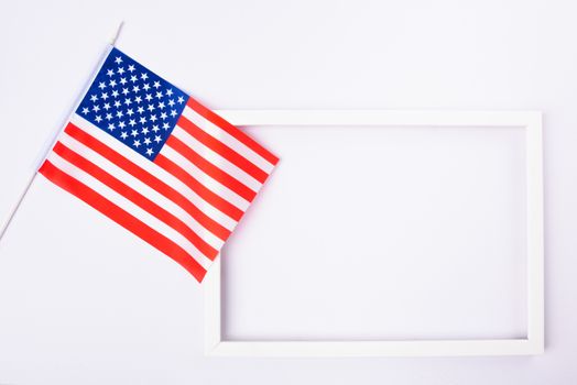 Martin luther king day, flat lay top view, American flag and photo frame on white background with copy space for your text